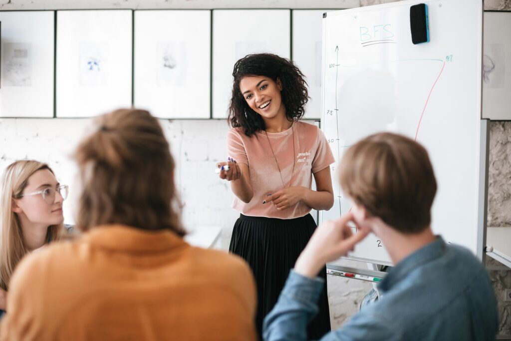 young-smiling-business-woman-giving-presentation